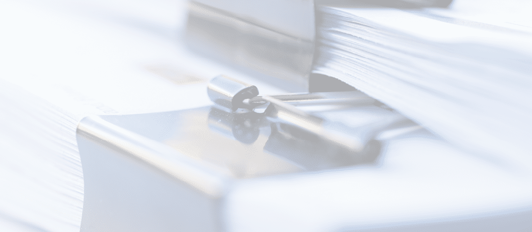 Piles of documents with black clip