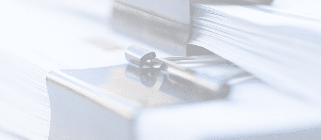 Piles of documents with black clip